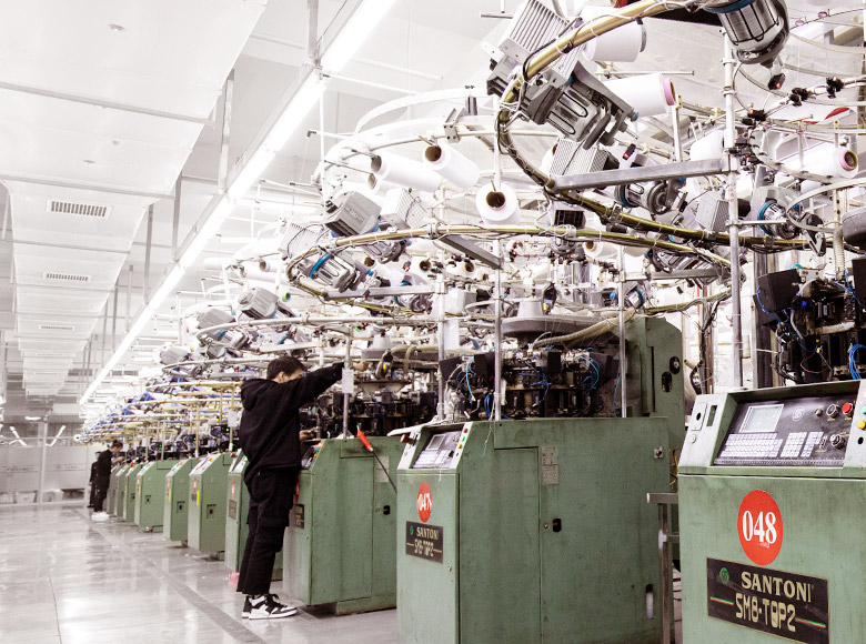 A line of SANTONI circular knitting machines in a workshop